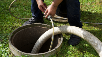 FJ-Rabon-Septic-Cleaning man pumping septic tank with hose